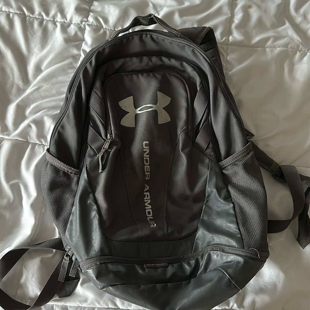 Gray under armor backpack with three zip compartment